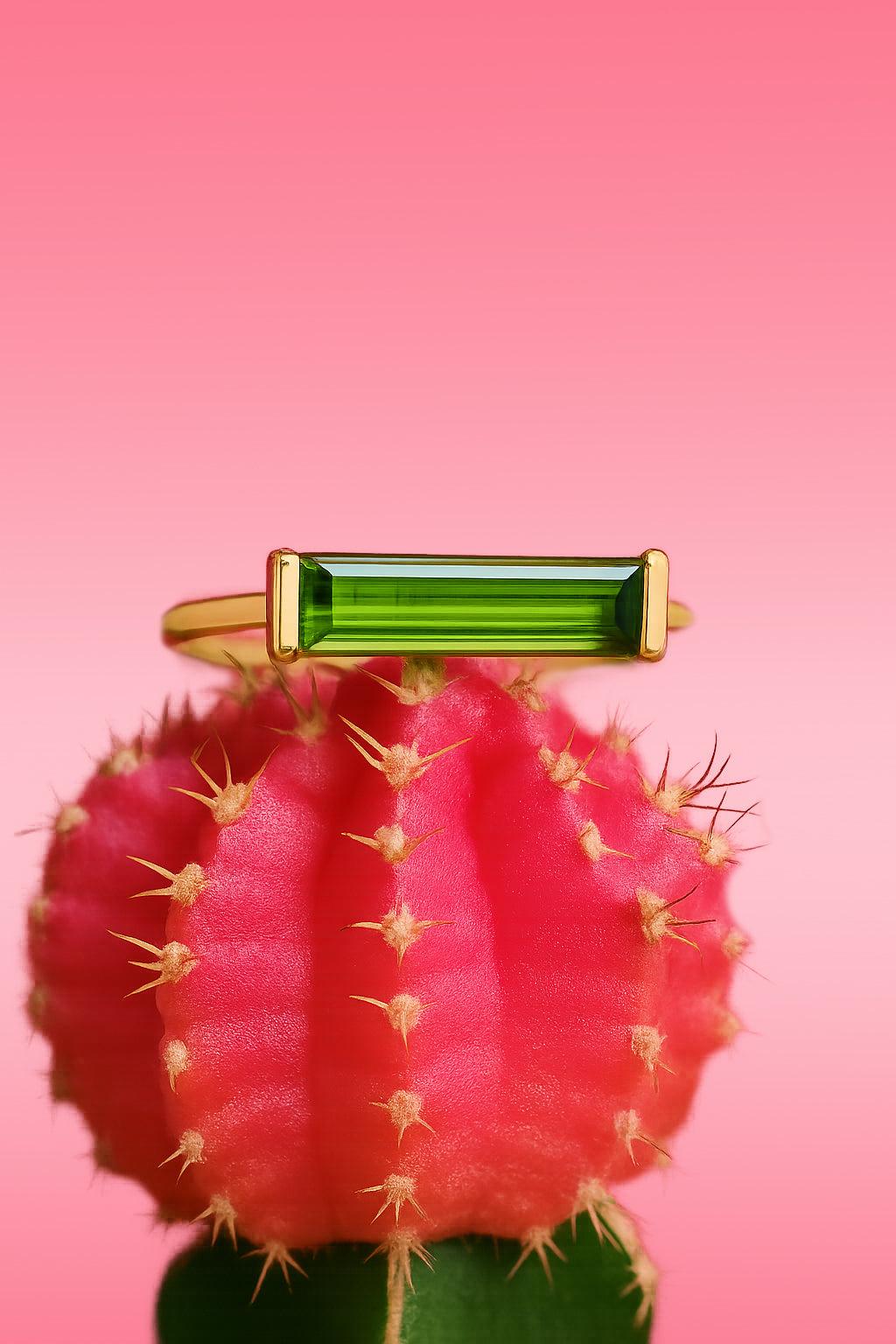 Colorful nature bar tourmaline green gemstone 14K gold ring resting on pink cactus