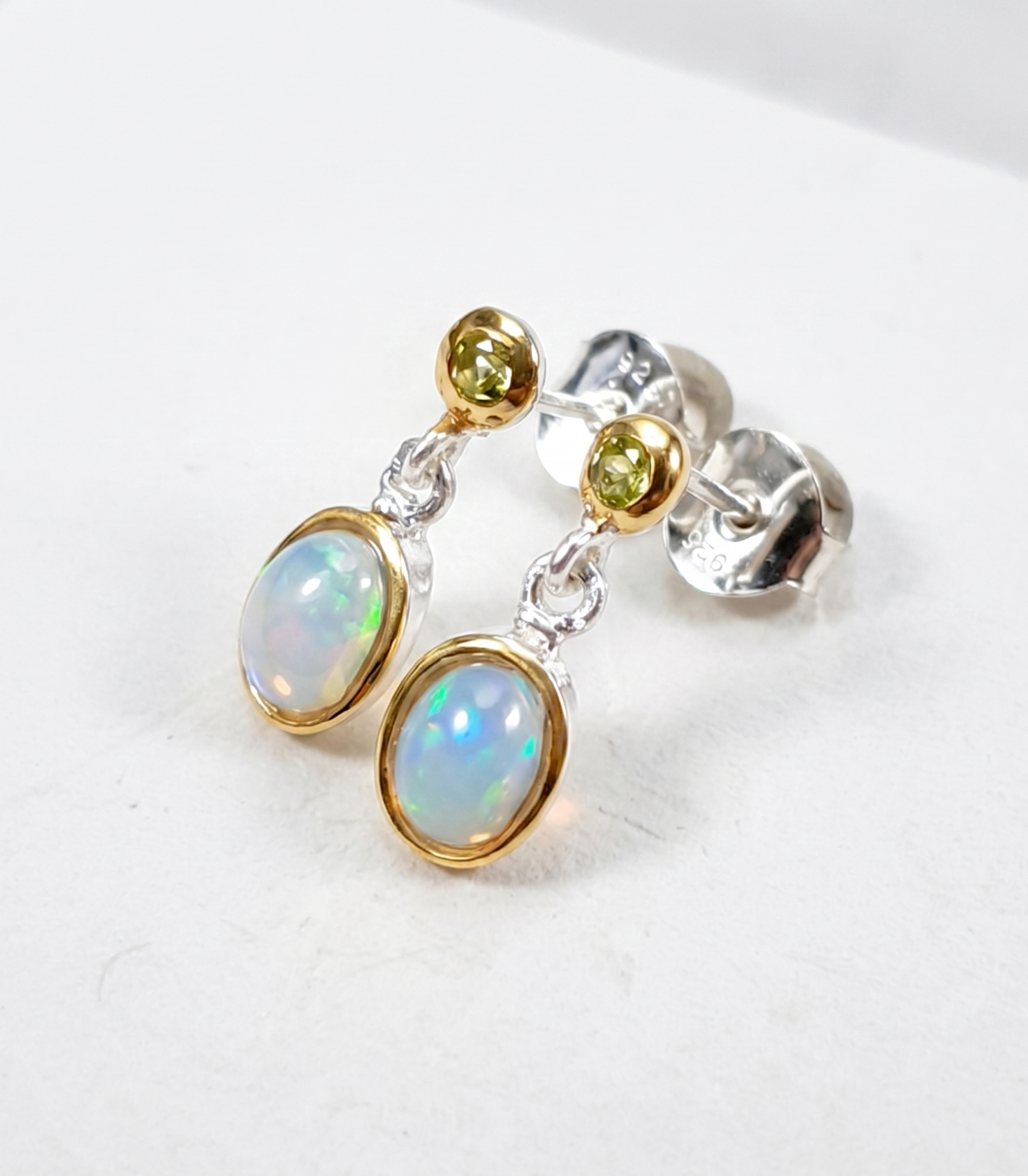 Pair of earrings with opal stones on a white background