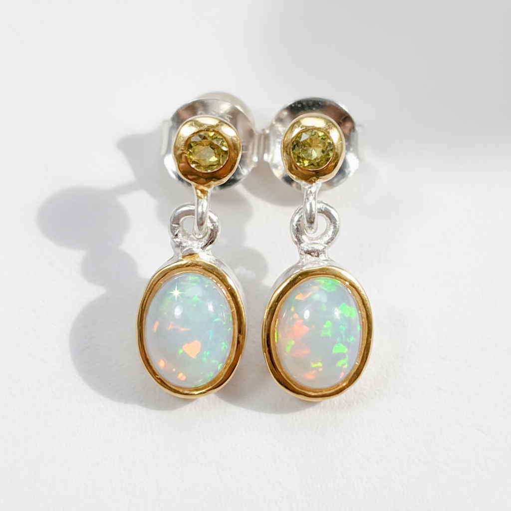 Pair of earrings with opal stones on a white background